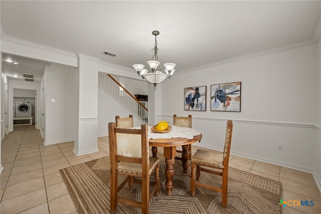 16503 Lounsbury Pl, Austin, TX 78717 - dining area with washer / clothes dryer, light tile patterned floors, crown molding, stairway, and a chandelier