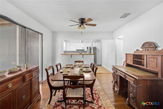 409 E Empresario St, Refugio, TX 78377 - dining space with a ceiling fan, visible vents, dark wood finished floors, and baseboards