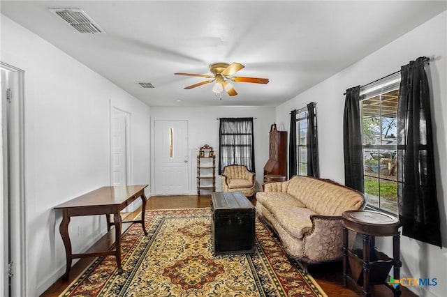 409 E Empresario St, Refugio, TX 78377 - interior space featuring ceiling fan, dark wood-style flooring, and visible vents