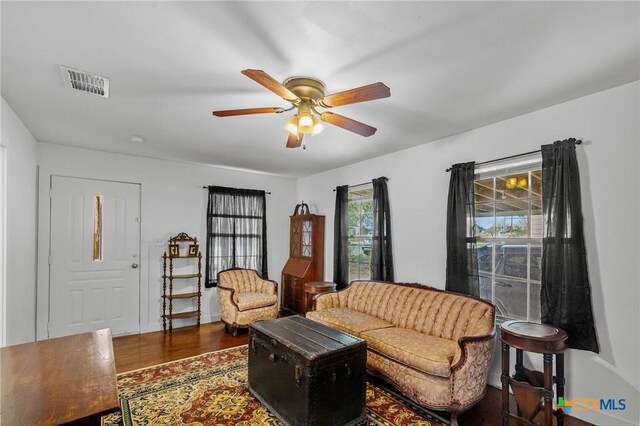 409 E Empresario St, Refugio, TX 78377 - living area with a ceiling fan, visible vents, and dark wood finished floors
