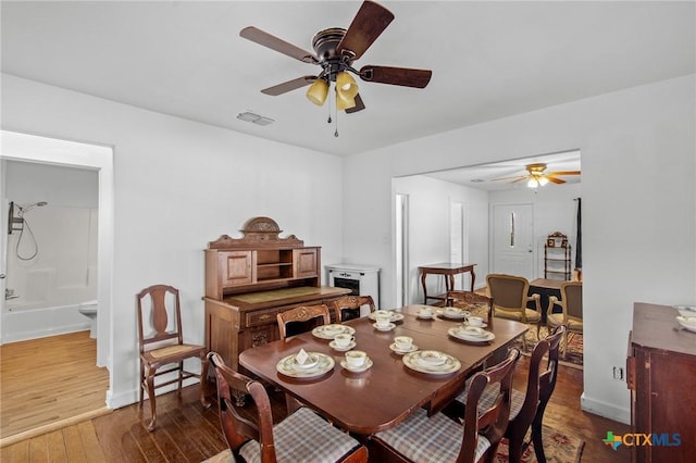 409 E Empresario St, Refugio, TX 78377 - dining space featuring dark wood-style floors, visible vents, baseboards, and a ceiling fan