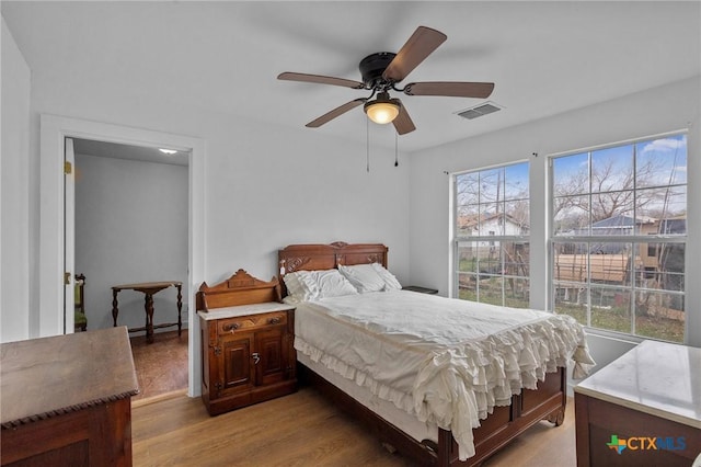 409 E Empresario St, Refugio, TX 78377 - bedroom featuring a ceiling fan, visible vents, and wood finished floors