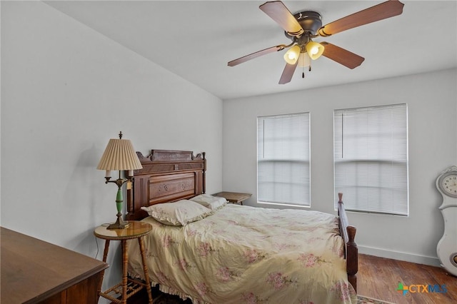 409 E Empresario St, Refugio, TX 78377 - bedroom with ceiling fan, wood finished floors, and baseboards