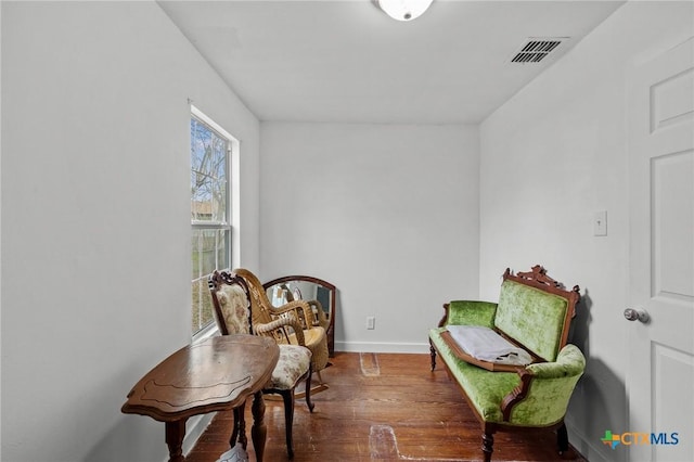 409 E Empresario St, Refugio, TX 78377 - sitting room featuring baseboards, visible vents, and dark wood finished floors