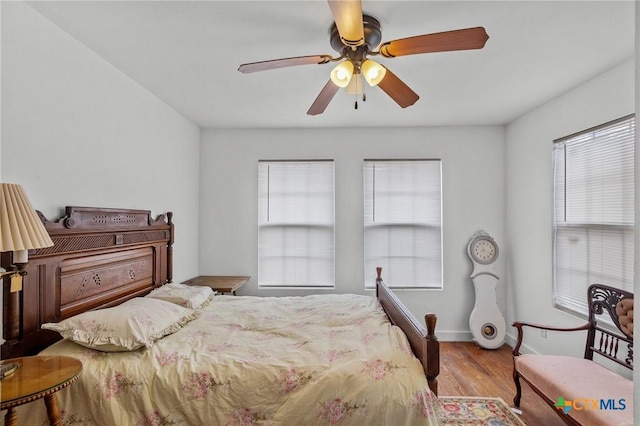 409 E Empresario St, Refugio, TX 78377 - bedroom with ceiling fan, light wood-style flooring, and baseboards