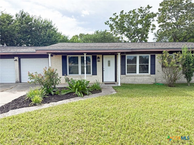 706 Edinburgh St, Victoria, TX 77904 - single story home featuring brick siding, concrete driveway, a garage, a front lawn, and a porch