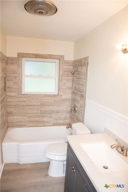 706 Edinburgh St, Victoria, TX 77904 - bathroom featuring vanity, wood finished floors, wainscoting, and tub / shower combination
