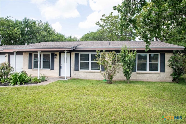706 Edinburgh St, Victoria, TX 77904 - ranch-style house featuring an attached garage, brick siding, a front yard, and roof with shingles