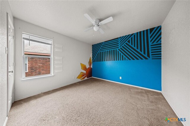 3810 John Haedge Dr, Killeen, TX 76549 - carpeted spare room featuring a ceiling fan and an accent wall