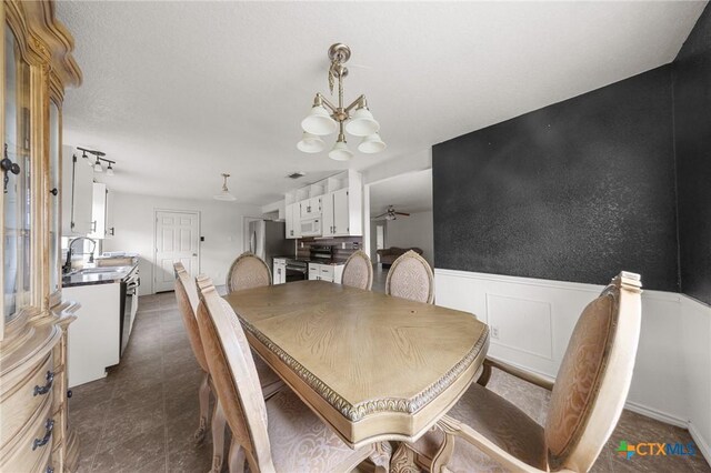3810 John Haedge Dr, Killeen, TX 76549 - dining room with a chandelier and a wainscoted wall