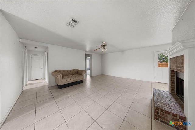 3810 John Haedge Dr, Killeen, TX 76549 - sitting room featuring ceiling fan, a fireplace, a textured ceiling, and light tile patterned floors