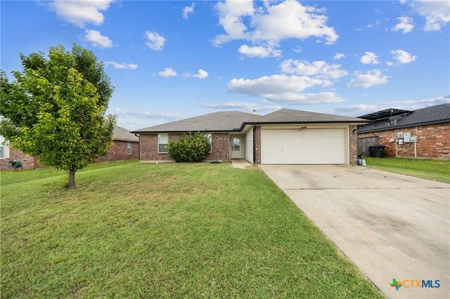 3810 John Haedge Dr, Killeen, TX 76549 - ranch-style house with brick siding, an attached garage, concrete driveway, and a front yard