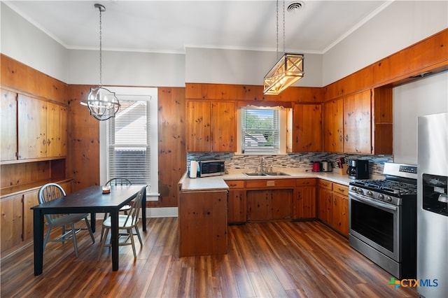 kitchen featuring dark hardwood / wood-style flooring, tasteful backsplash, appliances with stainless steel finishes, and sink