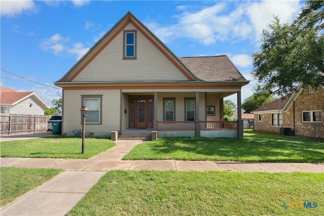 bungalow-style home featuring a porch and a front yard