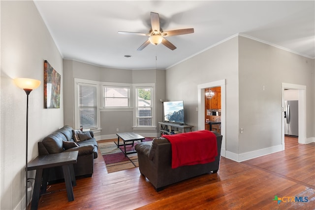 living room featuring ornamental molding, dark wood-type flooring, and ceiling fan