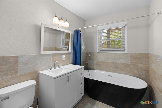 bathroom with toilet, vanity, tile walls, and a tub