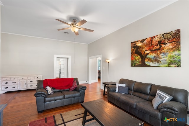 living room featuring hardwood / wood-style floors, ceiling fan, and crown molding