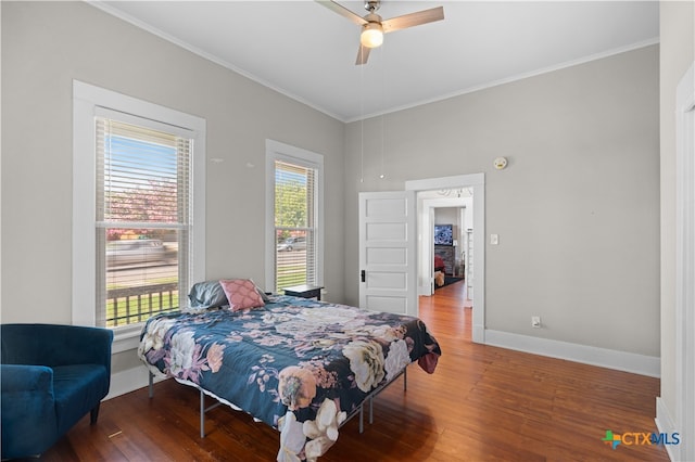 bedroom with ceiling fan, crown molding, and wood-type flooring