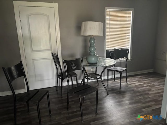dining area featuring baseboards and wood finished floors