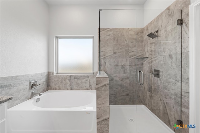 bathroom with separate shower and tub