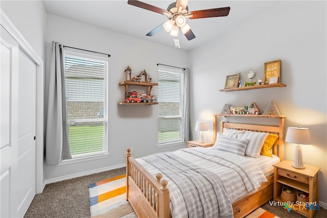 carpeted bedroom featuring a closet and ceiling fan