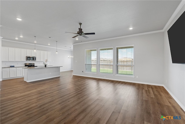 unfurnished living room with dark hardwood / wood-style flooring, sink, ornamental molding, and ceiling fan