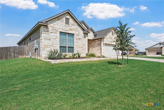 view of front of property with a garage and a front yard