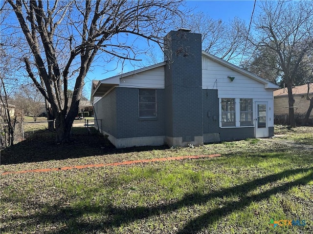 view of side of home featuring a lawn