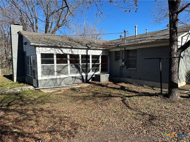 back of house with a yard, cooling unit, and a sunroom