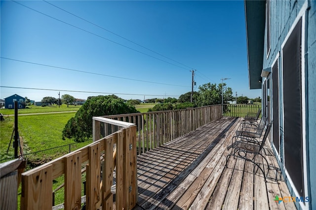 wooden deck with a lawn