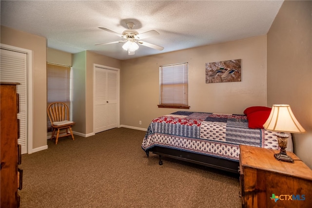 bedroom with a textured ceiling, dark carpet, and ceiling fan