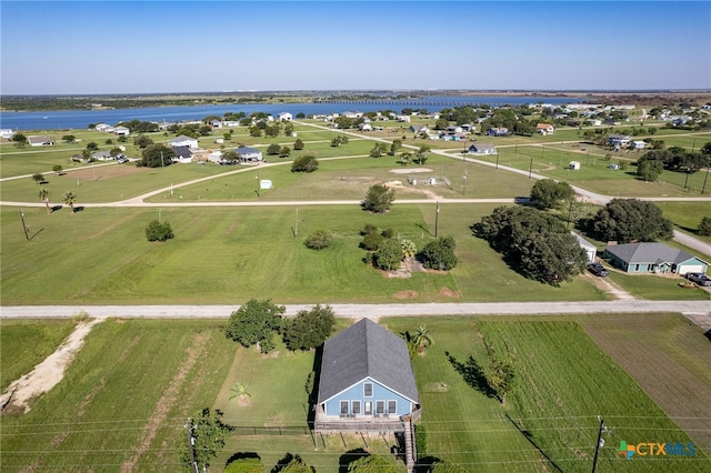 birds eye view of property with a water view and a rural view