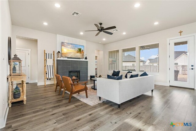 837 Gallant Fox Rd, Hewitt, TX 76643 - living area with wood finished floors, baseboards, a ceiling fan, a tiled fireplace, and recessed lighting