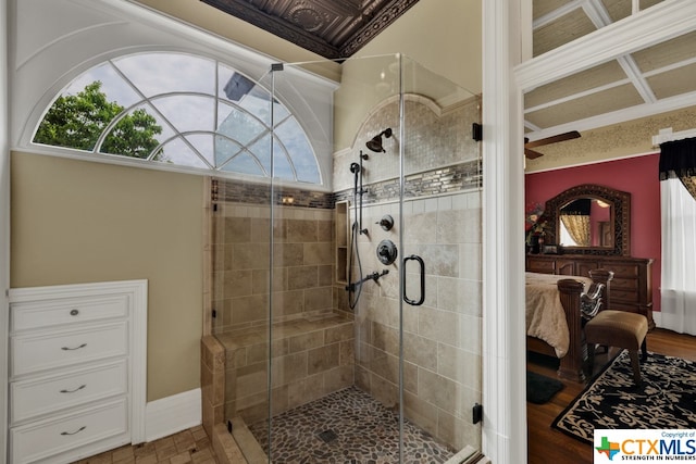 bathroom featuring hardwood / wood-style floors, an enclosed shower, and ceiling fan