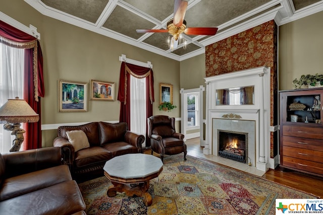 living room featuring hardwood / wood-style floors, ceiling fan, and ornamental molding