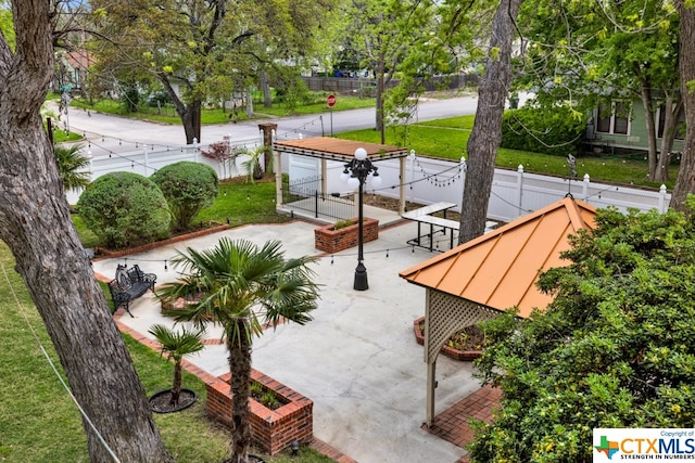 view of community with a patio and a lawn