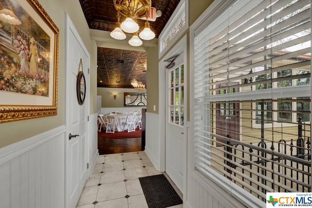 entryway featuring light hardwood / wood-style floors and a notable chandelier