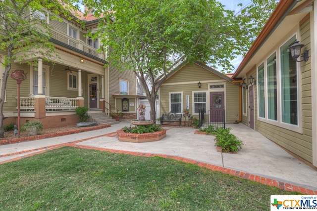 exterior space featuring a porch and a front yard