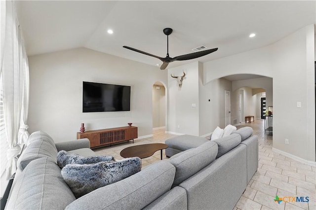 living area featuring visible vents, arched walkways, lofted ceiling, and a ceiling fan