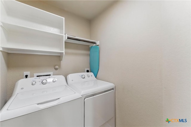 washroom with laundry area and washer and clothes dryer