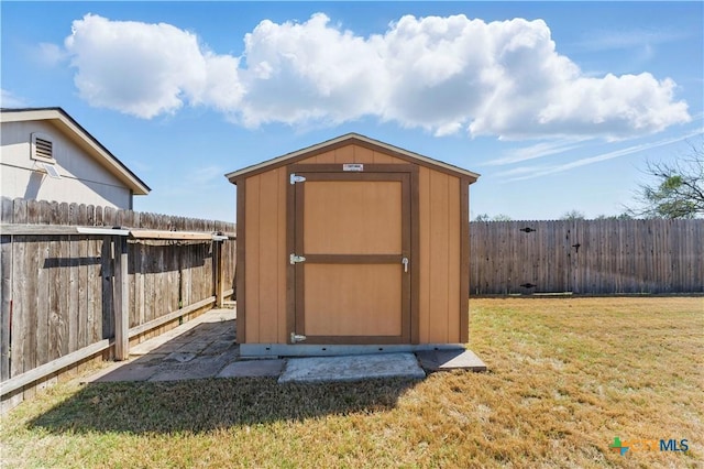 view of shed with a fenced backyard