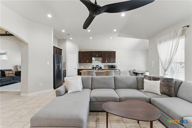 living room featuring visible vents, light tile patterned flooring, recessed lighting, arched walkways, and ceiling fan