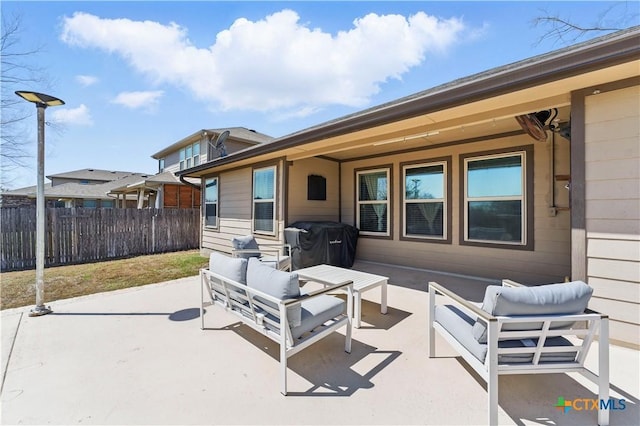 view of patio featuring an outdoor living space and fence