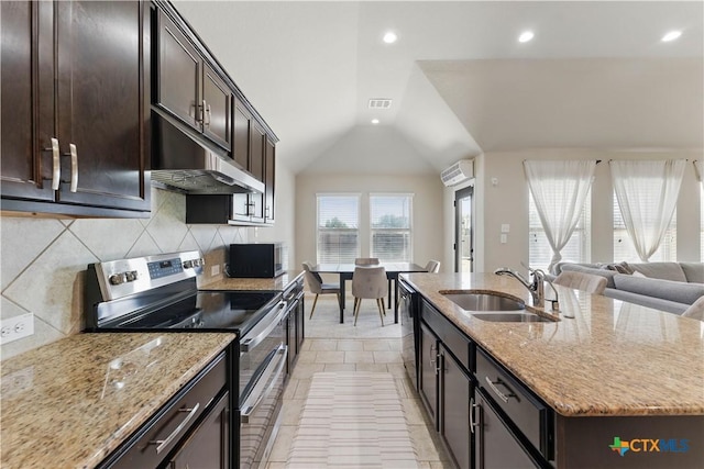 kitchen with visible vents, a kitchen island with sink, a sink, stainless steel appliances, and under cabinet range hood