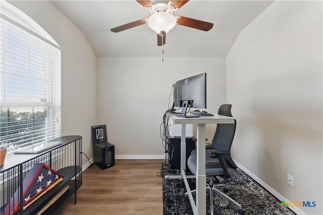 exercise room with a ceiling fan, baseboards, and wood finished floors