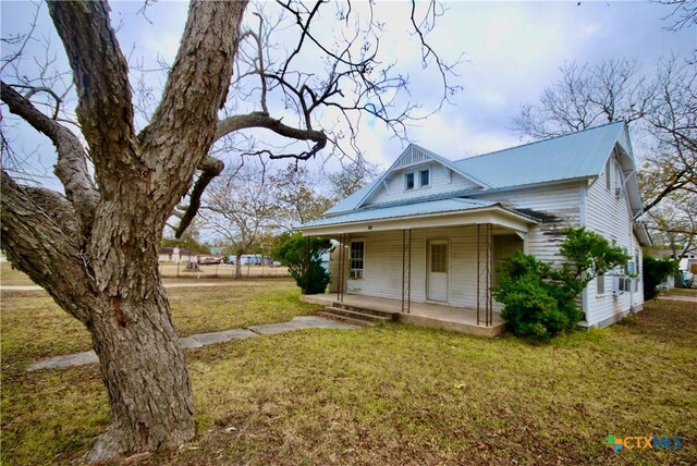 view of front of house with a front lawn and a porch