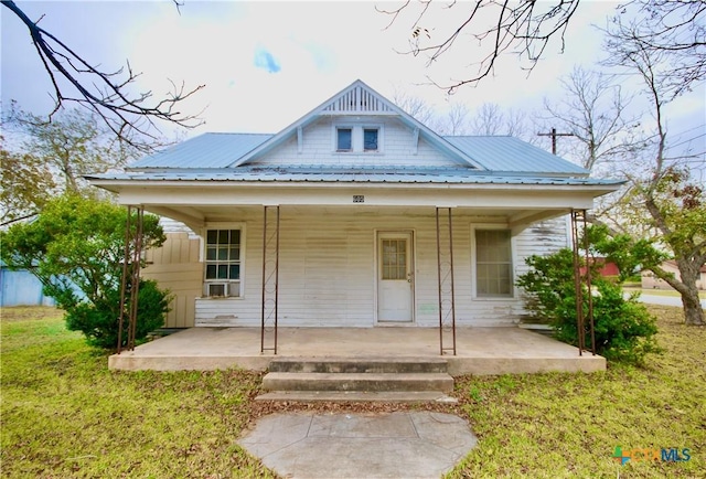 view of front of home featuring covered porch and a front yard