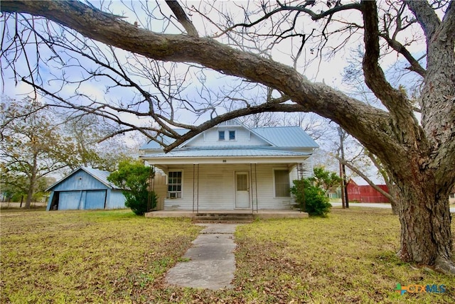 bungalow with covered porch and a front yard