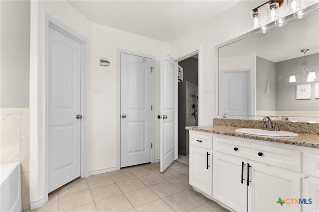 1037 Declaration Dr, Copperas Cove, TX 76522 - bathroom featuring vanity, a tub to relax in, tile patterned flooring, and a chandelier