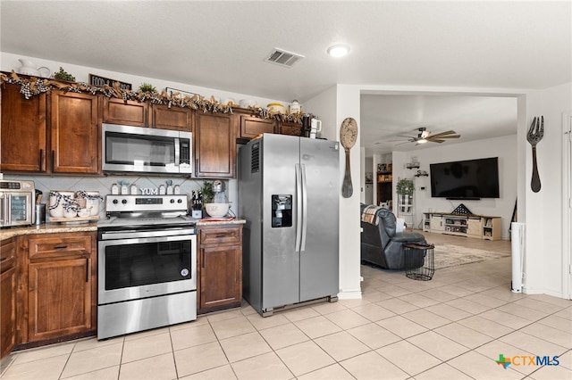 1037 Declaration Dr, Copperas Cove, TX 76522 - kitchen with stainless steel appliances, a ceiling fan, open floor plan, and light tile patterned flooring